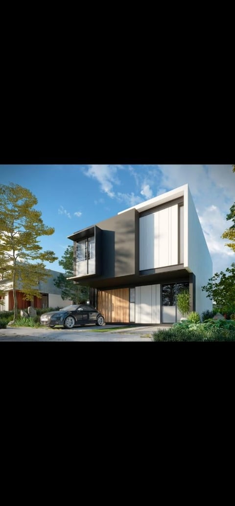 Modern two-story minimalist house with white and black exterior, large windows, carport, and surrounding landscaping under blue sky